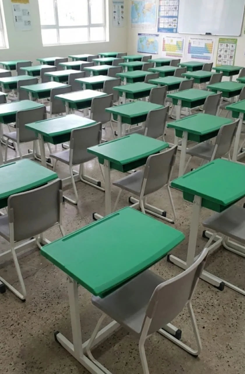 Green school desks and chairs